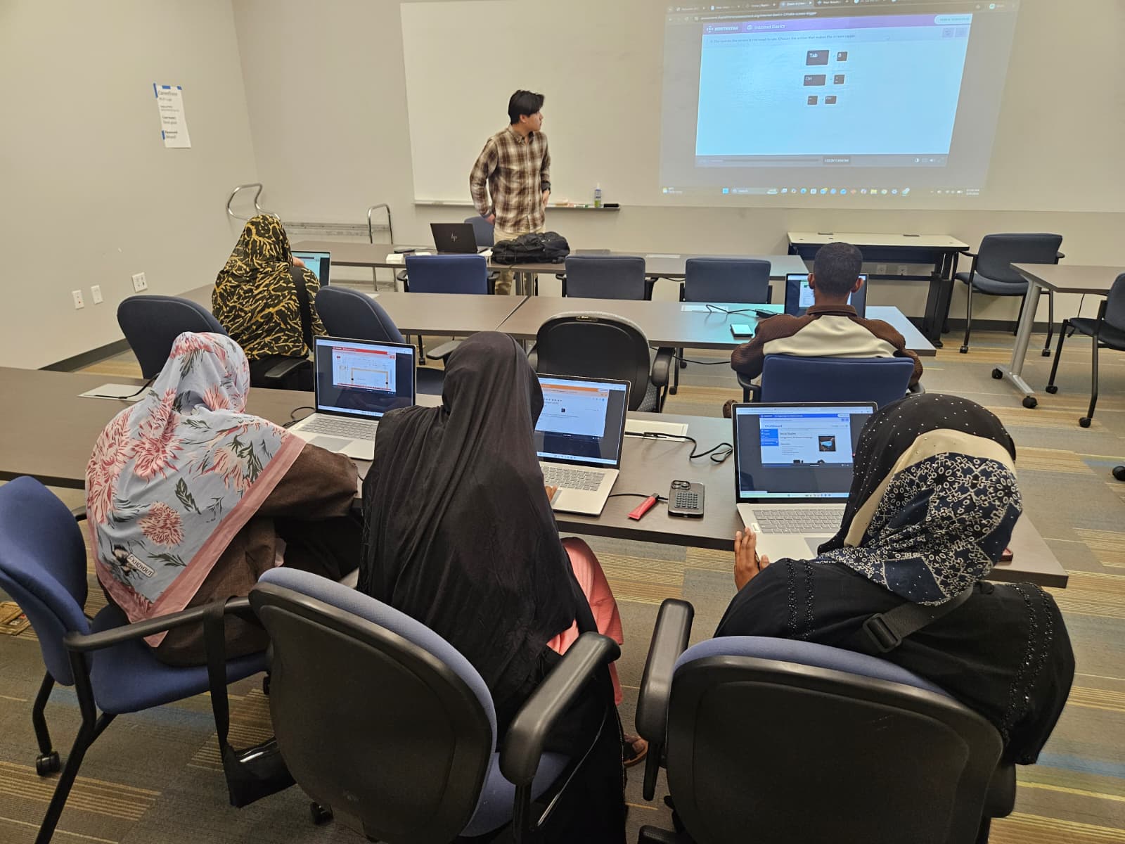 Victor teaching the digital literacy class in a CareerForce computer lab, with participants following along on laptops